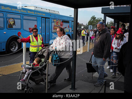 Disneyland guests wait to board a bus in the Woody Toy Story parking lot in Anaheim, CA Stock Photo