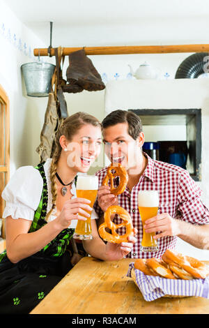 couple drinking wheat beer in bavarian restaurant Stock Photo