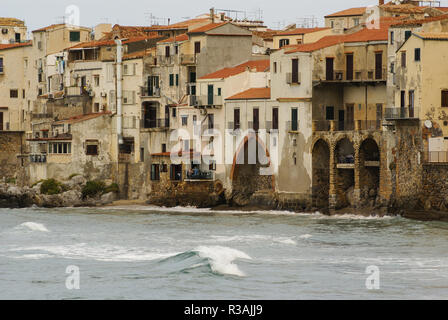 houses along the shoreline and cathedral in background,cefalu,sicily Stock Photo