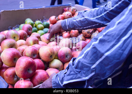 Freshly juicy picked heap of Red apples displayed for customer in a retail shop near roadside, Kolkata, India. Colorful fruit pattern. Business concep Stock Photo