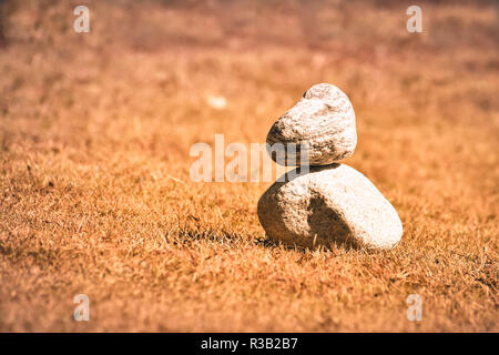 Heap of white stone stack of rock decoration in vertical style composition, copy space. Harmony, stability, strength, well being, concept. Useful in h Stock Photo