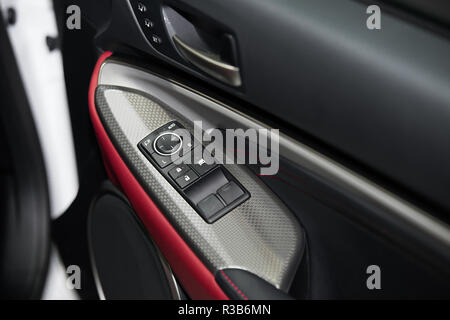 Detail on buttons controlling the windows in red car. Stock Photo