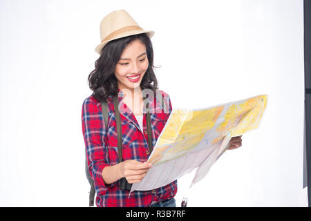 Woman travel. Young beautiful asian woman traveler watching map standing over white. Stock Photo