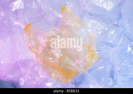 Colorful plastic bag on cement floor background. Stock Photo