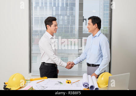 Architects working on plans at office, light effect Stock Photo