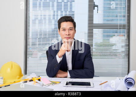 Male designer in office working on architects project Stock Photo