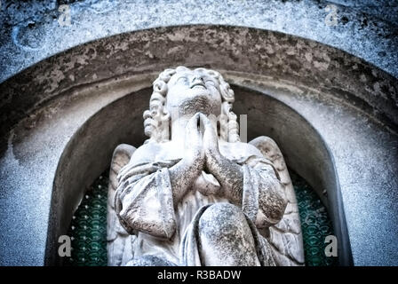 Sculpture of an angel praying in the Bellu cemetery, Bucharest, Romania Stock Photo