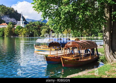 Traditional wooden pletnja rowing boat used to ferry tourists to St. Mary's Church of Assumption on the island beyond Lake Bled, Slovenia Stock Photo