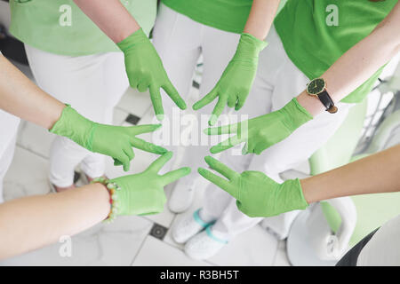 Doctors and nurses in a medical team stacking hands Stock Photo