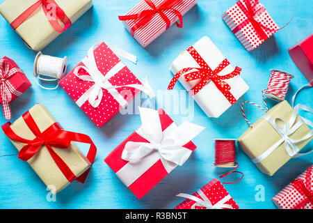 Packing  Christmas  present box on blue. Stock Photo