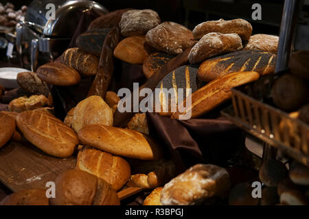 many rolls of different breads in the bakery restaurant Stock Photo