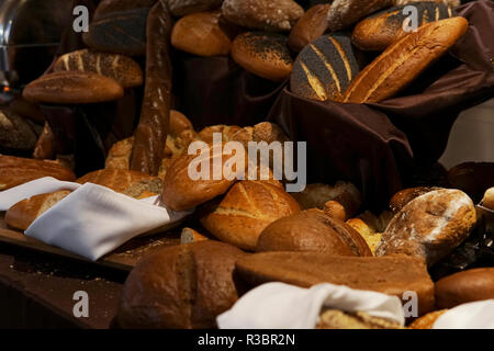 many rolls of different breads in the bakery restaurant Stock Photo