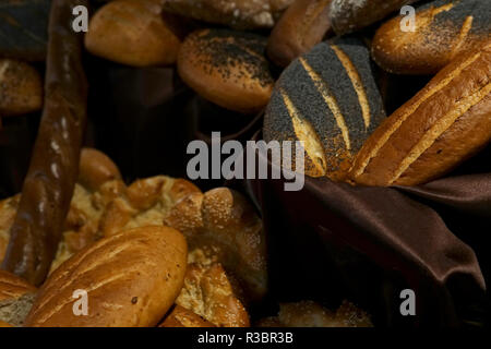 many rolls of different breads in the bakery restaurant Stock Photo