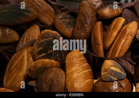 many rolls of different breads in the bakery restaurant Stock Photo