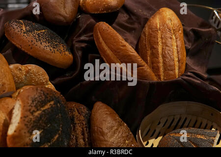 many rolls of different breads in the bakery restaurant Stock Photo