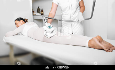 Shot of a woman getting a lpg massage on her buttocks Stock Photo