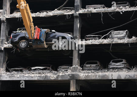 Burnt out cars and others that look undamaged but were written off by insurance companies due to fire and water damage are removed from their parking spaces as work began on Wednesday to demolish the multi-storey Liverpool Waterfront Car Park near to the Echo Arena which was destroyed by fire on New Year's Eve 2017. Stock Photo