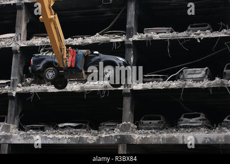 Burnt out cars and others that look undamaged but were written off by insurance companies due to fire and water damage are removed from their parking spaces as work began on Wednesday to demolish the multi-storey Liverpool Waterfront Car Park near to the Echo Arena which was destroyed by fire on New YearÕs Eve 2017. Stock Photo