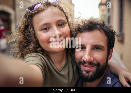 Father and young son taking selfies together in the city Stock Photo