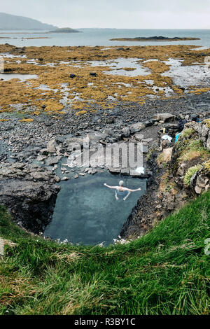 Hellulaug hot pool on the coast of Vatnsfjörður fjord in the Westfjords of NW Iceland. Stock Photo