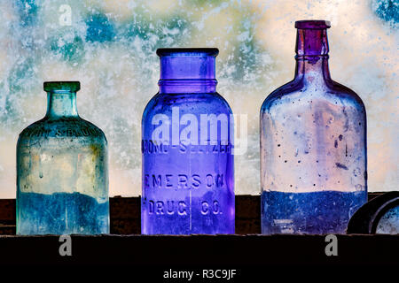 Antique colored bottles in window, Gold King Mine Museum and Ghost Town, Prescott National Forest, Jerome, Arizona Stock Photo