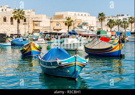 Traditional Maltese fishing boat luzzu in the Marsaxlokk harbour. Stock Photo