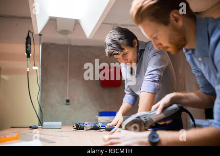 Two creative designers working in workshop Stock Photo