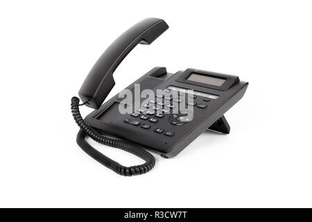 One black IP phone with a lifted handset, on a white background, close-up Stock Photo