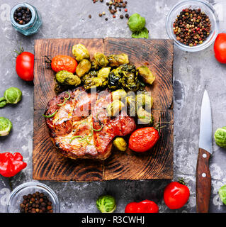 Grilled meat barbecue steak with brussels sprouts.Roast pork meat.Barbecue dish. Stock Photo