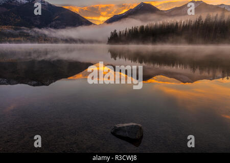 Sunrise fog on Holland Lake in the Flathead National Forest, Montana, USA Stock Photo