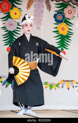 Okinawa, Japan - March 10, 2013 : Unidentified female dancer performing Okinawa traditional dance at Shuri Castle Stock Photo