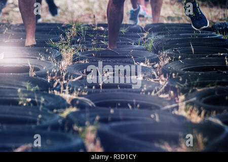 Low section of people receiving tire obstacle course training Stock Photo