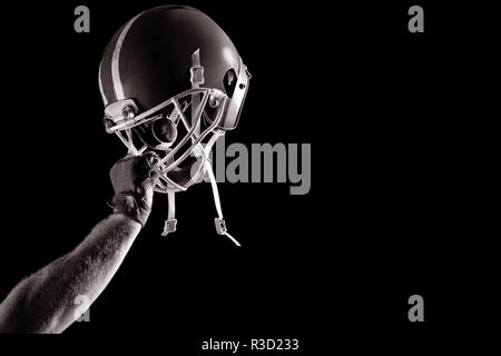 American football player cheering with arm up Stock Photo