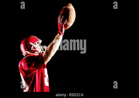 American football player cheering with arm up Stock Photo