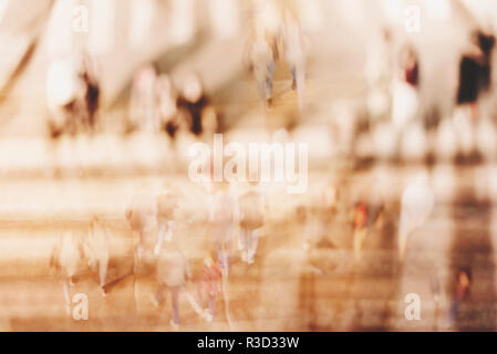 Blurred background. Blurred people walking through a city street. Toned photo. Stock Photo