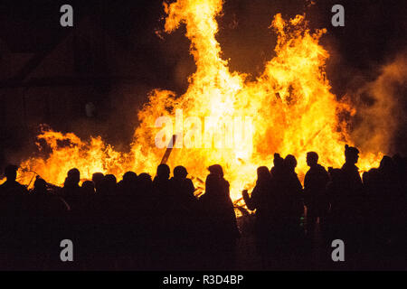 Silhouettes of people celebrating in front of a large bonfire on November 5th Guy Fawkes Night in England, UK Stock Photo