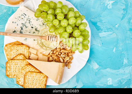 Italian antipasti wine snacks set. Antipasto catering platter with jerky, salami, cheese , grapes, olives, pickles, Prosciutto with melon, Brushettas. Stock Photo