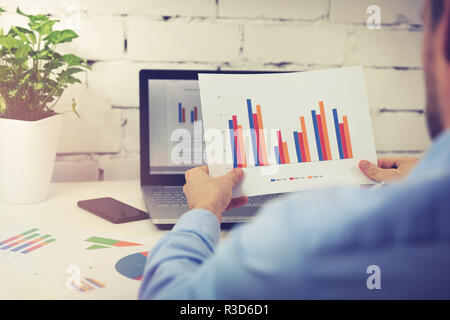 office worker analyzing financial business data reports Stock Photo