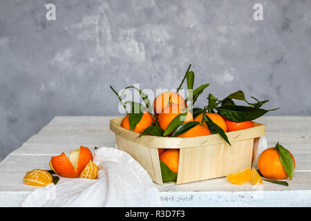 Tangerines on a white wooden table and a grey background Stock Photo