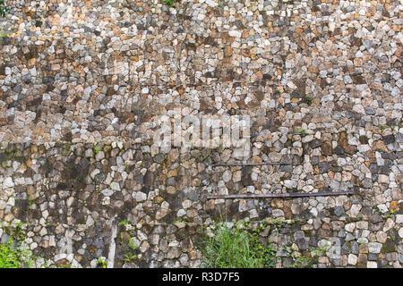big broken stone wall, rubble work wall, with grass colorful and abstract old wall, artfully crafted Stock Photo