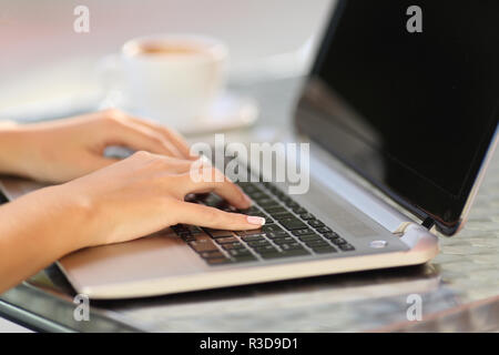 Woman hands working with a laptop in a coffee shop Stock Photo
