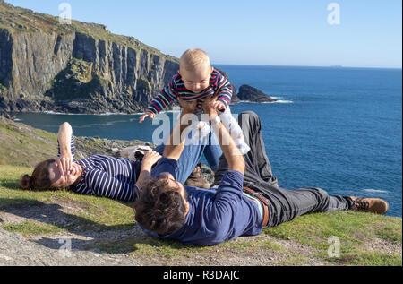 family on summer holiday with small child on a cliff top or clifftop Baltimore west cork ireland Stock Photo