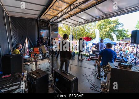 Faversham Hop Festival 2018, Margate group Project F, soul funk party band on stage. View from back of covered stage of band and outdoors audience Stock Photo