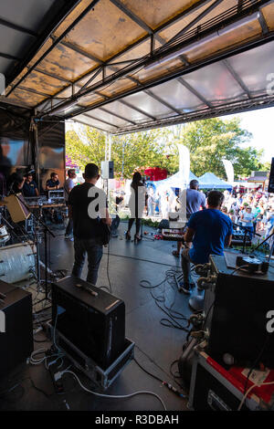 Faversham Hop Festival 2018, Margate group Project F, soul funk party band on stage. View from back of covered stage of band and outdoors audience Stock Photo