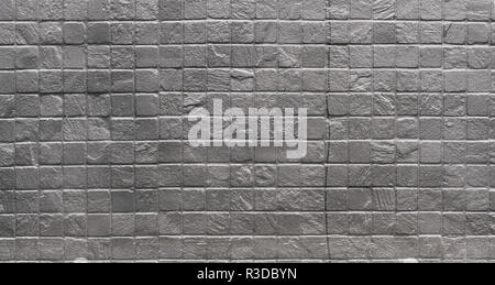Grunge industrial silver painted square brick wall background in Kyiv, Ukraine. May be used in design and interiors. Stock Photo