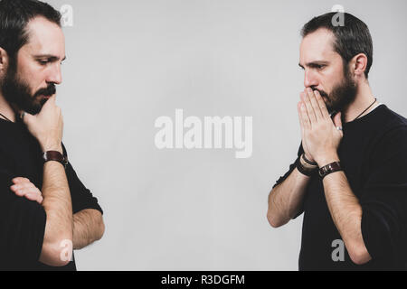 Bearded worried man on grey background. Stock Photo
