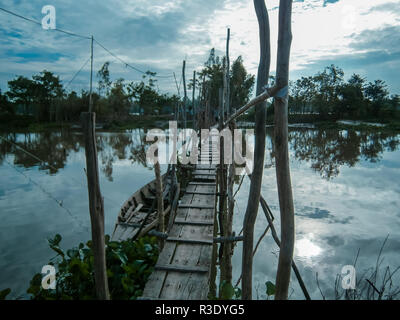 Wooden walkway over water in Vietnam Stock Photo