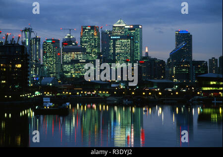Buildings at Canary Wharf in the early evening, reflected in Royal Victoria Dock, Silvertown, East London UK Stock Photo