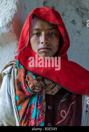 Veiled harari young woman in red, Harari Region, Harar, Ethiopia Stock Photo