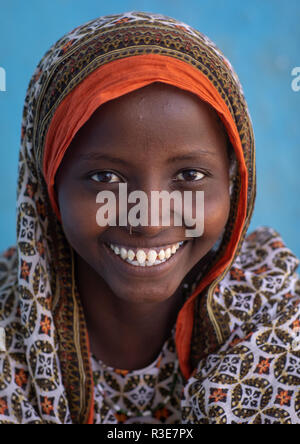 Portrait of a veiled smiling afar tribe girl with sharpened teeth, Afar ...